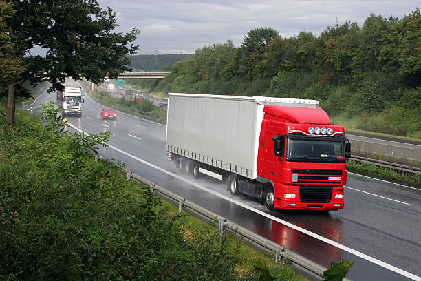 Truck on three-lane highway stock photo