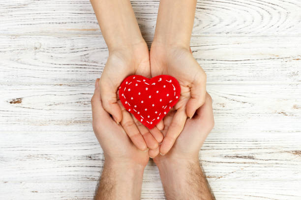 istock help, Heart in Hand on wood background. Valentine day concept 903837052