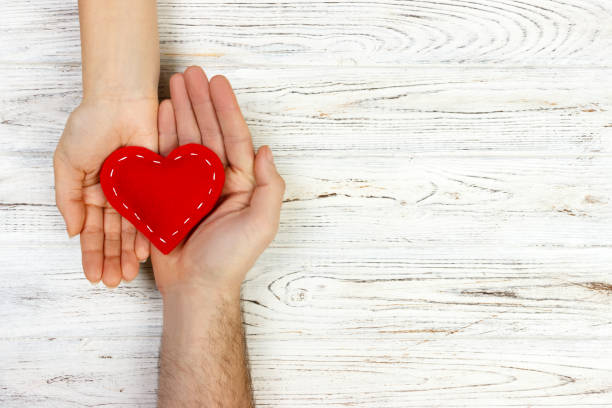istock help, Heart in Hand on wood background. Valentine day concept. copy space 903837130