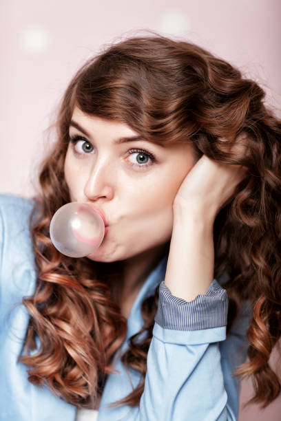 istock woman doing bubble with chewing gum 903837490