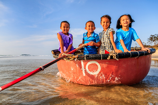 Group of happy Vietnamese children have fun on the beach, Vietnam