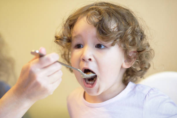 istock Mother feeds the baby with a spoon 903841232