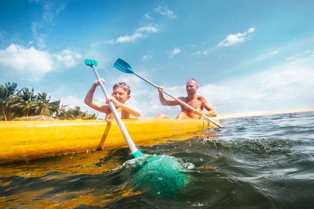 istock Father and son are sailing in the canoe 903841454