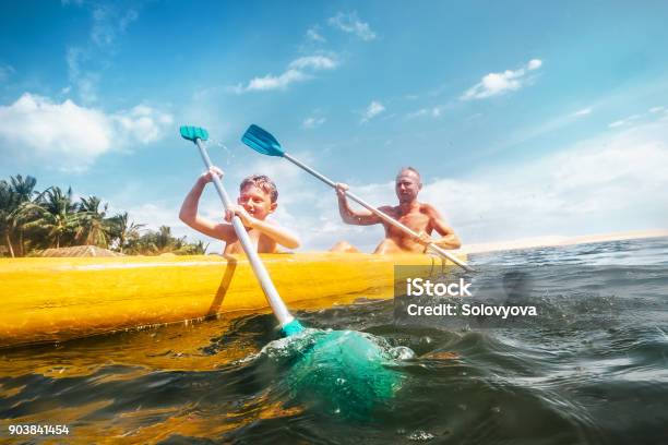 Father And Son Are Sailing In The Canoe Stock Photo - Download Image Now - Family, Kayak, Vacations