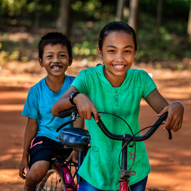 istock Cambodian children riding bicycle, Cambodia 903841926