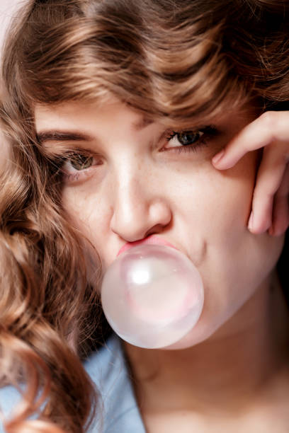 istock woman doing bubble with chewing gum 903842558