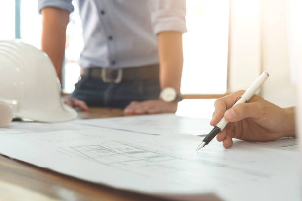 istock Image of engineer or architectural project, Close up of hands architects engineering working on blueprint with engineering equipment tool, Construction concept 903843186