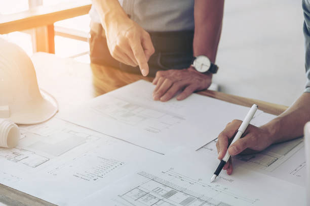 istock Image of engineer or architectural project, Close up of hands architects engineering working on blueprint with engineering equipment tool, Construction concept 903845464