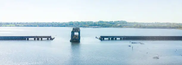 Photo of Middle Branch Patapsco river panorama with railroad swing bridge during day in Baltimore, Maryland, USA