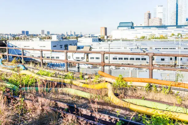 View of the Hudson Yards train depot and building development from the High Line, an elevated urban park in New York City, NYC with art decorative pipes