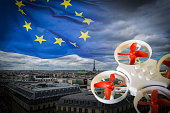Mini drone flying over Paris cityscape