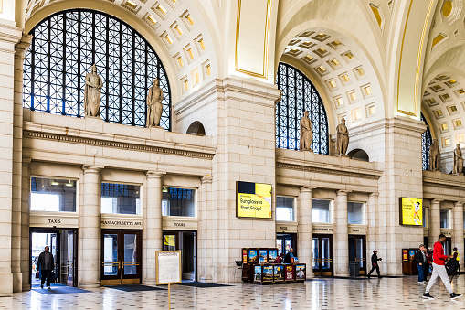 Washington Dc: Inside Union Station in capital city with people walking inside entrance, tall ceilings and architecture