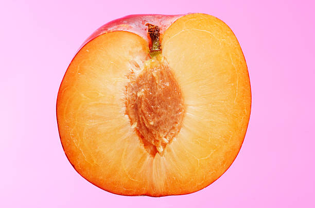istock sliced halved ripe fruit plum against pink background 90385459