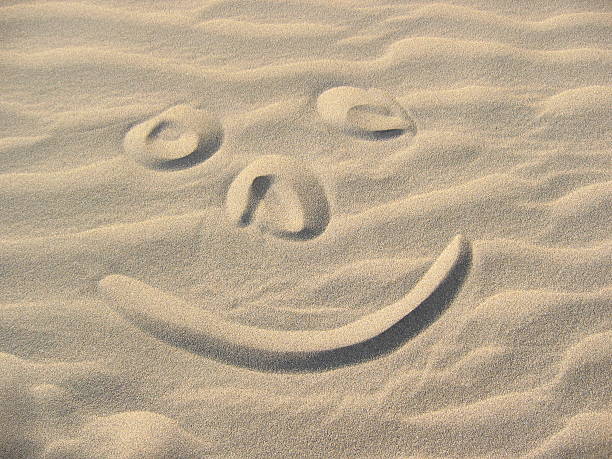 smiley в песок - abrasiveness стоковые фото и изображения