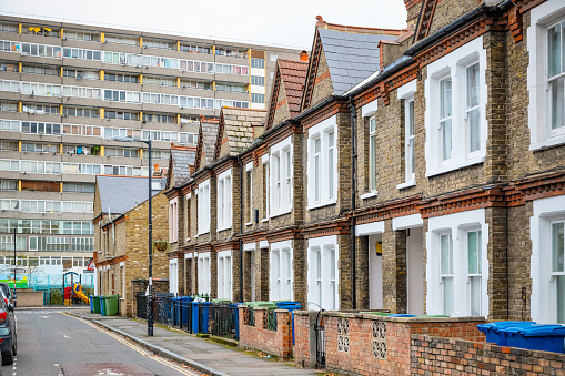 Traditional English terraced houses with huge council block in the background