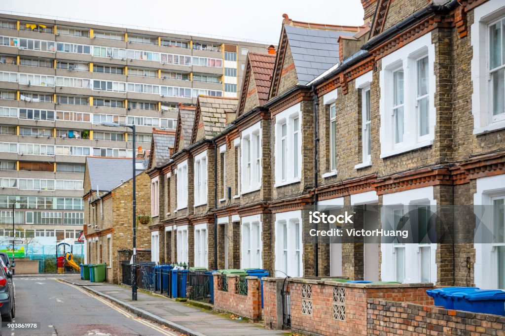 Traditional English terraced houses with huge council block in the background Traditional English terraced houses with huge council block in the background in south east London Public Housing Stock Photo