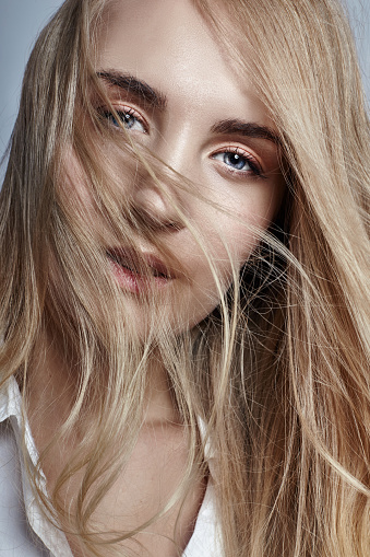 Mysterious And Romantic With Long Blonde Hair Waving In The Wind Woman In The White Shirt Beautiful Eyes And Clear Skin Sensual Girl Look Dynamic Hair Stock Photo - Download Image Now - Mysterious And Romantic With Long Blonde Hair Waving In The Wind Woman In The White Shirt Beautiful Eyes And Clear Skin Sensual Girl Look Dynamic Hair Stock Photo - Download Image Now -