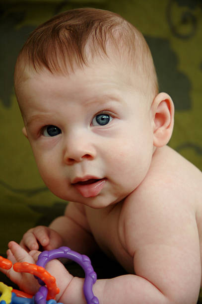 Baby boy on green stock photo