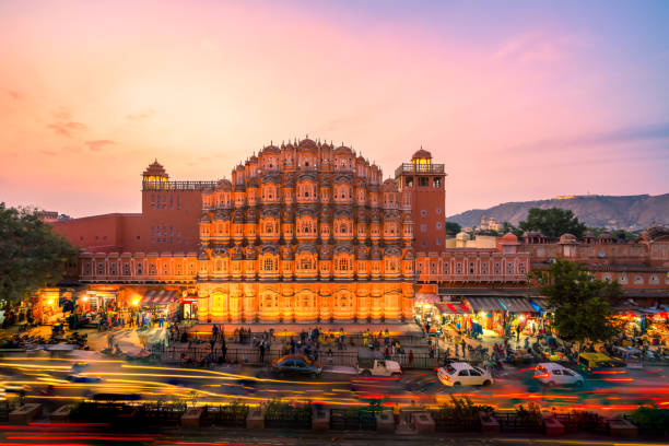 The crowd and vehicles in front of Hawa Mahal Jaipur - December 15, 2017: The crowd and vehicles in front of Hawa Mahal, India at the evening. india jaipur rajasthan traditional culture stock pictures, royalty-free photos & images