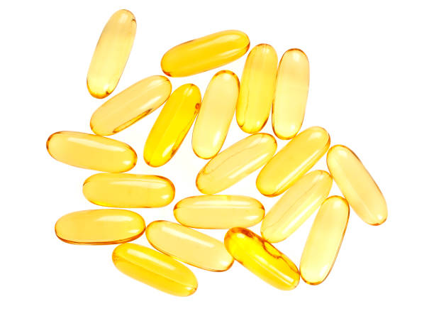 istock Cod liver oil omega 3 gel capsules isolated on white background, top view 903888440