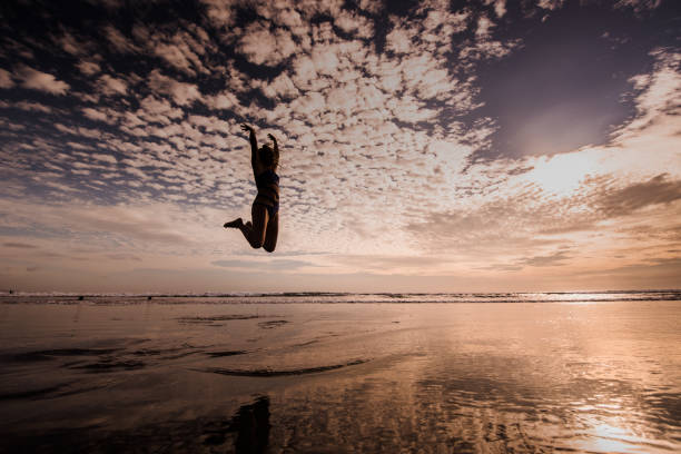 istock Young female jumping on the tropical beach. 903895908