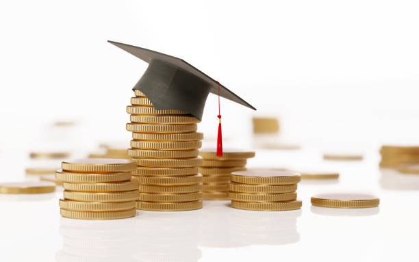 istock Stack Of Coins And A Black Mortarboard On White Background - Education And Savings Concept 903904602