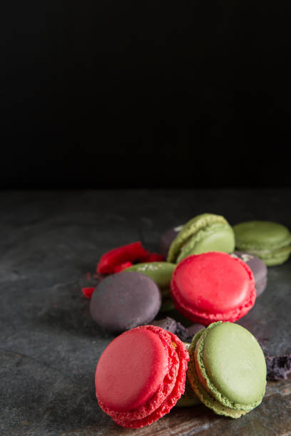 istock French dessert macaroons with pistachios and strawberries. Dark background 903904914