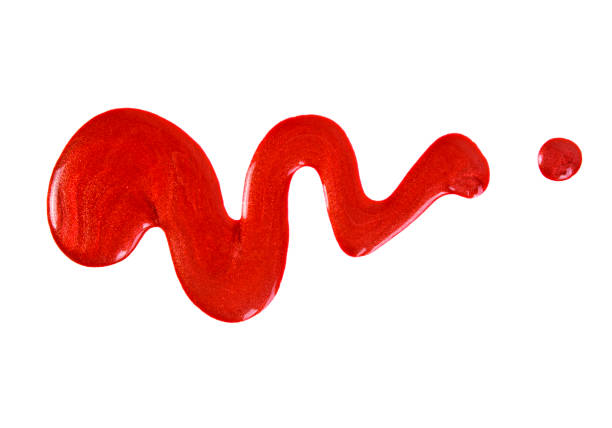 istock Spilled red nail polish isolated on white background 903908072