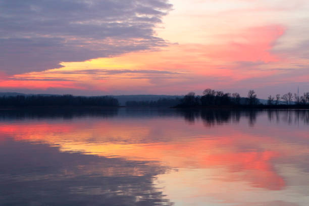 istock Red sunset with a symmetrical reflection in the water. 903908096
