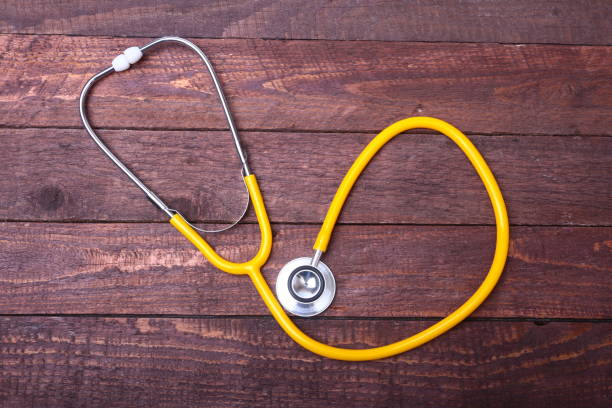 istock Medical stethoscope and tablets isolated on wooden background 903908536