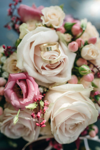 istock Bridal bouquet with golden rings 903910710