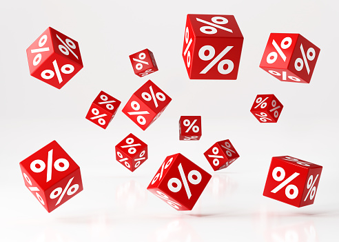 Sale concept, Red cubes with percentage symbols are falling over white reflective surface. standing Horizontal composition with copy space. Clipping path is included. Great use for shopping and Valentine's Day Christmas and Mother\
