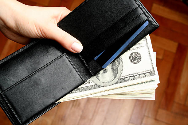 istock Wallet with money coming out of it 90391544