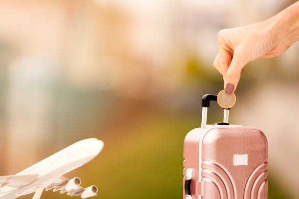 istock Miniature toy airplane and suitcases on bokeh background 903921266