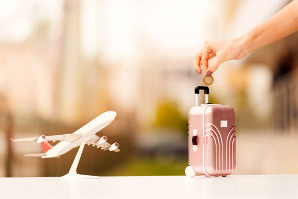 istock Miniature toy airplane and suitcases on bokeh background 903921268
