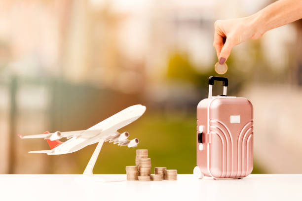 Miniature toy airplane and suitcases on bokeh background stock photo