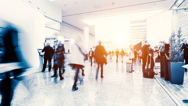 blurred crowd of people in a futuristic environment futuristic concept of blurred crowd of people in a business environment tradeshow photos stock pictures, royalty-free photos & images