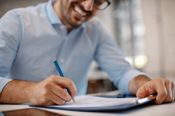 Young businessman signing a contract stock photo