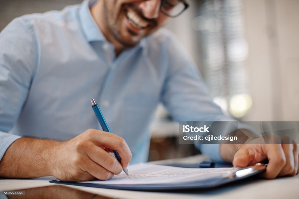 Jovem Empresário assinatura de um contrato - Foto de stock de Contrato royalty-free