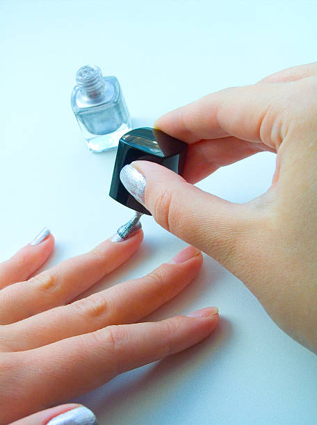 istock The girl varnishs nails 90392575