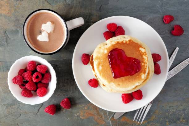 istock Love concept breakfast pancakes, hot chocolate and raspberries over slate 903925778