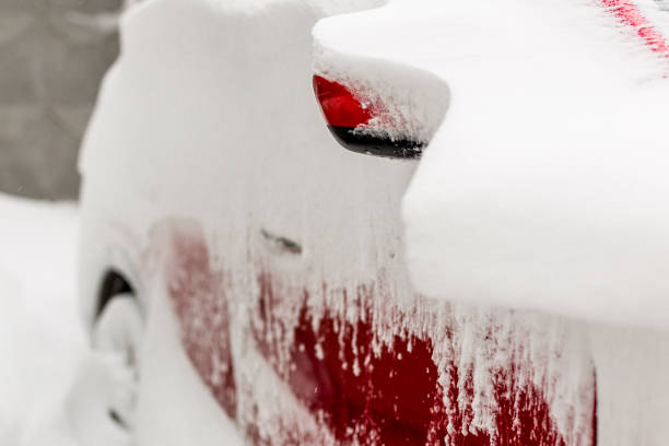 istock Car on a street covered with big snow layer. 903925954