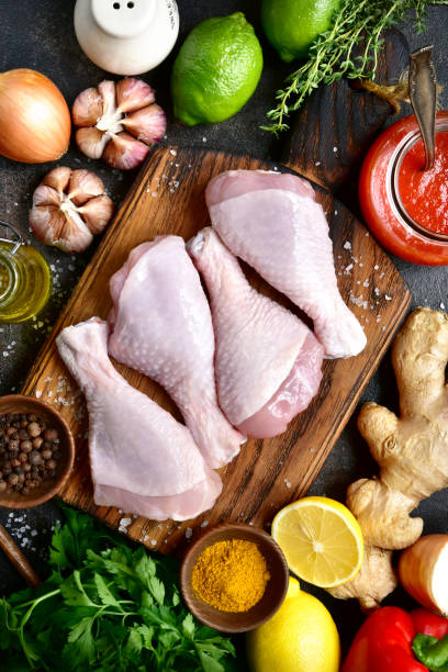 istock Raw organic chicken legs with ingredients for cooking 903927512