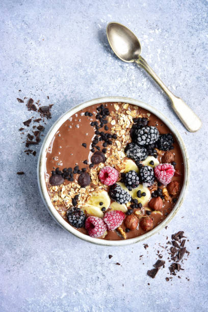 istock Chocolate banana smoothie bowl with frozen berries 903928346