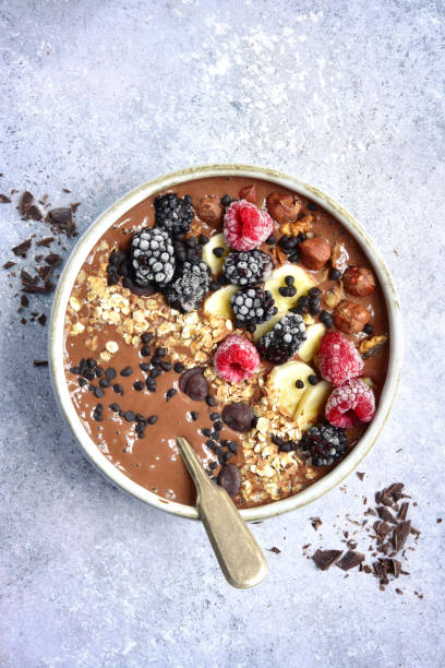 istock Chocolate banana smoothie bowl with frozen berries 903928368