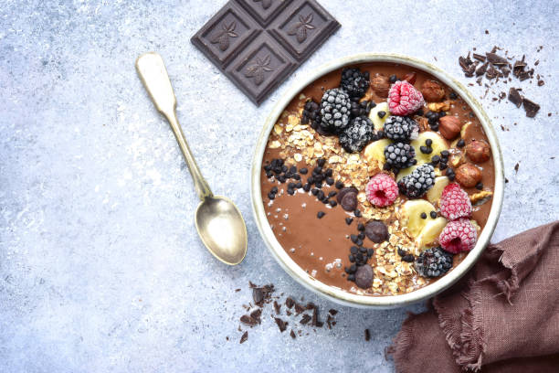 istock Chocolate banana smoothie bowl with frozen berries 903928392