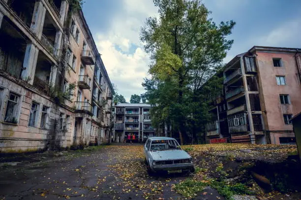 Abandoned mining ghost-town Jantuha, Abkhazia. Destroyed empty houses, the remains of the cars, remnant of The Georgian-Abkhazian war