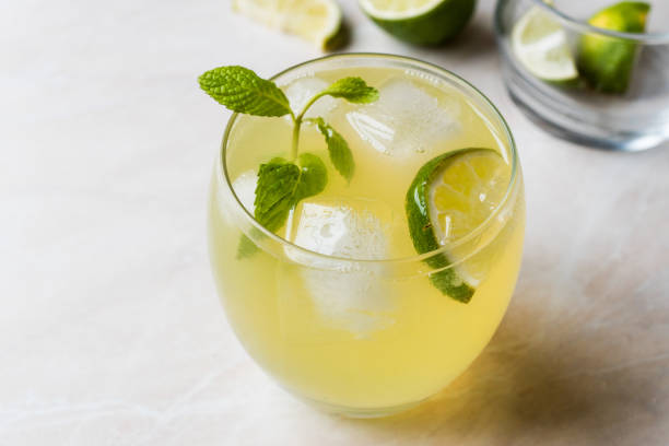 istock Yellow Lemonade Cocktail with Lime and ice. 903935498