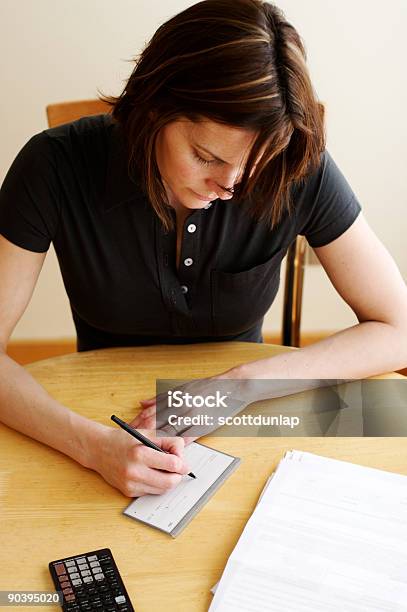 Woman Paying Bills Stock Photo - Download Image Now - Adult, Beautiful People, Brown Hair