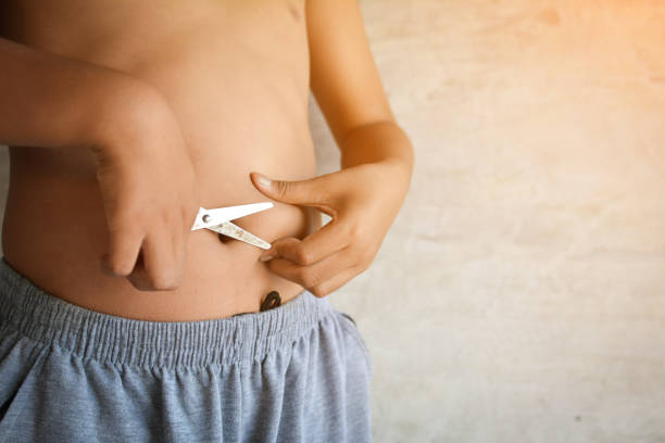 istock Midsection Of Boy Cutting Belly With Scissors 903953378